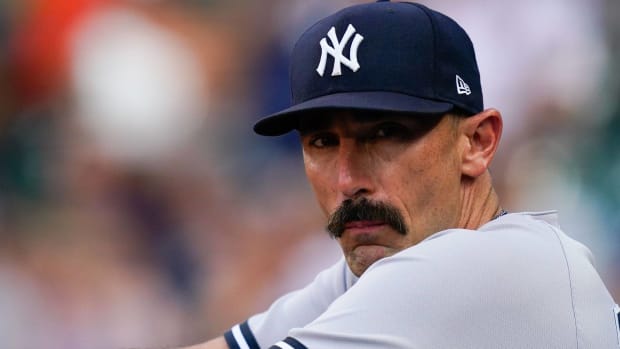 Yankees hitter Matt Carpenter looks at a camera while in the dugout.